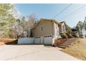View of home's side and driveway, leading to a spacious two-car garage at 31 Wyngate Ct, Dallas, GA 30157