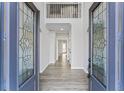 Stunning foyer with decorative glass doors, wood-look floors and wrought iron railing at 4275 Azalea Walk, Ellenwood, GA 30294