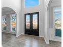 Inviting foyer featuring new wood-look floors and views of the home's bright interior at 4275 Azalea Walk, Ellenwood, GA 30294