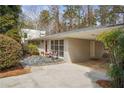 Exterior showing a single-story home featuring a carport and landscaped front yard at 2711 Winding Ne Ln, Brookhaven, GA 30319