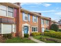 Attractive brick townhome with colorful shutters and a well-kept lawn at 6105 Queen Anne Ct, Norcross, GA 30093