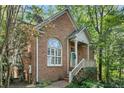 Attractive brick home with a covered porch and lush landscaping at 31 Greenland Trce, Atlanta, GA 30342