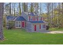 Inviting two-story home showcasing a well-kept lawn and a quaint brick accent at 5338 Timor Trl, Lithonia, GA 30038