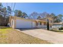 Traditional home with an attached garage and an extended driveway on a sunny day at 774 Marthas Dr, Lawrenceville, GA 30045