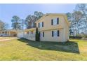 Inviting exterior view of a well-maintained two-story home with a grassy lawn and attached garage at 774 Marthas Dr, Lawrenceville, GA 30045