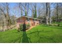 Well-maintained brick home with a beautiful lawn and mature trees at 2664 Homeland Dr, Atlanta, GA 30360