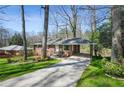 Charming brick home featuring a carport and well-maintained front yard at 2664 Homeland Dr, Atlanta, GA 30360