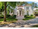 Charming two-story home with lush landscaping, a private driveway, and a red tile roof at 401 Peachtree Battle Nw Ave, Atlanta, GA 30305