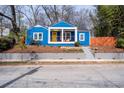 Charming blue bungalow with a cozy front porch, bright yellow door, and landscaped front yard at 674 Atlanta Se Ave, Atlanta, GA 30312