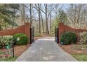 Brick gate and brick-paved driveway create a grand entrance to this private estate at 0 Winterthur, Sandy Springs, GA 30328