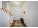 Bright foyer with hardwood floors, a staircase, a bench, and a white front door at 120 Centennial Ridge Dr, Acworth, GA 30102
