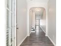 Inviting hallway features an arched entryway and stylish wood-look flooring at 2398 Chancery Mill Ln, Buford, GA 30519