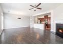 Open-concept living room with fireplace flows into the kitchen with stainless appliances at 2398 Chancery Mill Ln, Buford, GA 30519