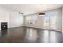 Spacious living room features a fireplace, ceiling fan, and French doors to the outside at 2398 Chancery Mill Ln, Buford, GA 30519