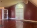 Bedroom with a large arched window with white blinds, and french doors at 294 Hascall Nw Rd, Atlanta, GA 30309