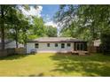 Large backyard featuring a newly constructed deck with sliding glass doors, perfect for entertaining guests at 3235 Bluebird Ln, Decatur, GA 30032