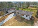 Charming home with modern white exterior, well-manicured lawn, and a long concrete driveway at 3235 Bluebird Ln, Decatur, GA 30032