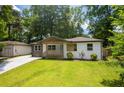 Craftsman-style bungalow with fresh exterior paint, modern color accents, and an inviting front lawn at 3235 Bluebird Ln, Decatur, GA 30032