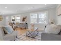 Bright living room with modern furniture, neutral colors, and plenty of natural light from large windows at 3235 Bluebird Ln, Decatur, GA 30032