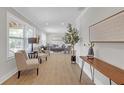 Open-concept living room featuring stylish decor, light wood floors, and abundant natural light at 3235 Bluebird Ln, Decatur, GA 30032