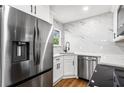 Modern kitchen featuring stainless steel appliances, white cabinets, and elegant marble countertops at 1150 Rankin St # 6H, Stone Mountain, GA 30083