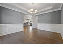Dining room featuring elegant wainscoting, a chandelier, and hardwood floors at 206 Lotus Ln, Covington, GA 30016