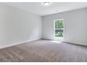 Cozy bedroom with plush carpet, natural light from the window, and neutral paint at 218 Lotus Ln, Covington, GA 30016