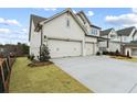 Elegant home with a three-car garage and newly installed sod at 227 Wild Ginger Bnd, Woodstock, GA 30188