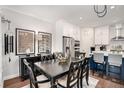 Elegant dining room with a dining table and chairs, designer lighting, and easy access to the kitchen at 233 Retreat Ln, Canton, GA 30114