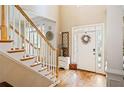 Bright foyer with hardwood floors, a staircase, and a front door with sidelights at 4204 Rockpoint Nw Dr, Kennesaw, GA 30152