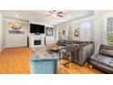 Sunlit living room features hardwood flooring, fireplace, and refined furniture at 2402 Palladian Manor Se Way # 3, Atlanta, GA 30339