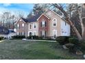 Charming two-story home featuring a brick and stucco facade, well-maintained landscaping, and a welcoming front entrance at 3920 Vine Gate Dr, Lithonia, GA 30038