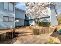 Cozy townhome featuring blue siding and mature landscaping with a beautiful tree in the front yard at 922 Lakewood Ln, Jonesboro, GA 30238