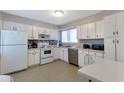 Well-lit kitchen with white cabinets, stainless steel appliances and tile backsplash at 922 Lakewood Ln, Jonesboro, GA 30238