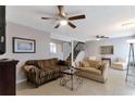 Spacious living room with neutral paint, tile flooring, ceiling fan and staircase at 922 Lakewood Ln, Jonesboro, GA 30238