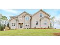 Stunning two-story brick home with a well-manicured lawn and beautiful landscaping at 211 Lotus Ln, Covington, GA 30016