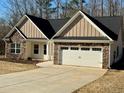 Charming single-story home with stone accents, attached two-car garage, and manicured lawn at 415 Smallwood Lane, Douglasville, GA 30134
