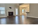 Spacious living room with hardwood floors, a cozy fireplace, and open concept layout at 415 Smallwood Lane, Douglasville, GA 30134