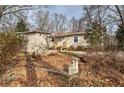 Cozy one-level home featuring a small wooden porch and surrounded by well-maintained landscaping and mature trees at 58 Knox Rd, Powder Springs, GA 30127