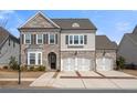 Charming home with a two-car garage, brick and siding facade, and an inviting front yard at 6180 Bellmoore Park Ln, Duluth, GA 30097