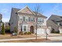 Attractive home with two-car garage, brick and siding exterior, complemented by a well-kept lawn at 6180 Bellmoore Park Ln, Duluth, GA 30097