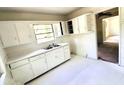 Bright kitchen with white cabinets, double sink, and ample counter space at 2075 Dellwood Pl, Decatur, GA 30032