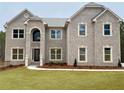 Stately brick home featuring a well-manicured lawn and a classic architectural design with multiple windows at 3118 Old Covington Hwy, Covington, GA 30014