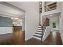Inviting foyer with staircase, hardwood floors, and open view to the kitchen and formal living areas at 3728 Old Covington Rd, Conyers, GA 30013