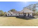 Attractive single-story home boasting a classic design, charming front porch and lush green lawn at 2418 Claude Brewer Rd, Loganville, GA 30052