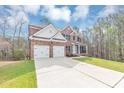 Charming two-story brick home with a two-car garage and well-manicured front lawn under a blue sky at 2784 Hilson Commons, Decatur, GA 30034