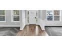 Inviting foyer featuring hardwood floors transitioning to carpet, complemented by elegant trim and ample natural light at 2784 Hilson Commons, Decatur, GA 30034