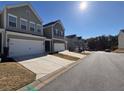 Street view of elegant townhomes, each with a two-car garage and manicured lawns in a serene neighborhood at 501 Crescent Woode Dr, Dallas, GA 30157