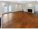 Spacious living room with hardwood floors, fireplace, built-in shelving, and french doors to the outside at 156 Page Pl, Canton, GA 30114