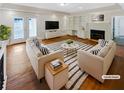 Bright living room features hardwood floors, a fireplace, and built-in shelving with neutral decor at 156 Page Pl, Canton, GA 30114